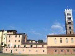 Lucca Duomo with prominent campanile under a clear blue sky