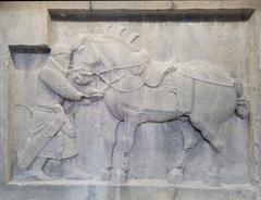 Limestone relief of Saluzi with general pulling an arrow from its chest