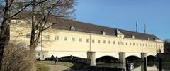 Stauwehr Oberföhring on the Isar River with water flow and surrounding greenery