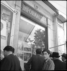 Men standing in front of a market hall window in Lisbon, Portugal