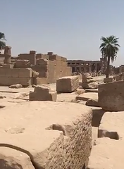 Ancient City ruins with collapsed stone structures and scattered debris under a bright blue sky