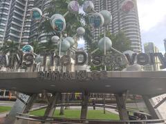 Suria KLCC bus stop with people waiting and modern architecture in the background