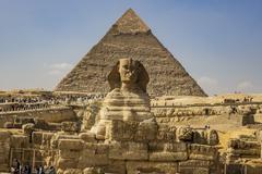 Pyramids in Cairo, Egypt, with a hazy sky and surrounding cityscape