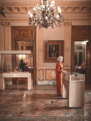 Beautiful girl in colorful dress at the Royal Jewelry Museum in Alexandria