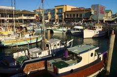 Fisherman's Wharf waterfront with tourists, restaurants, and ferries