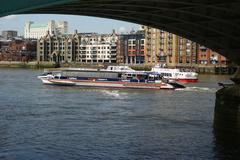 Ferries on the River Thames under Southwark Bridge in London