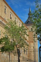 Historic cityscape view of Toledo, Spain, with the prominent Alcázar palace and Tagus River