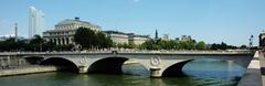 Pont au Change from Île de la Cité in Paris featuring Fontaine du Palmier, Tour Saint-Jacques under renovation, and Théâtre de la Ville on the left.