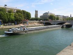 Coupled barges in Paris in front of pont au Change bridge