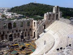 Odeon of Herodes Atticus at the Acropolis in Athens with Philopappos Monument in the background