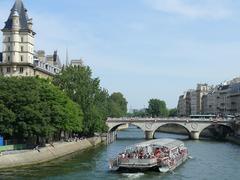 Jeanne Moreau boat on Seine River with Saint-Michel Bridge and Palais de Justice in Paris