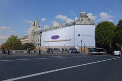 south facade of the Palais de Justice covered by an advertising canvas seen from the Pont Saint-Michel in Paris, France