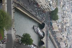 View from Notre-Dame de Paris with Bateau-Mouches boat passing under Pont Saint-Michel in Paris, France