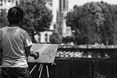 artist painting the Pont des Arts in Paris