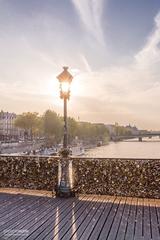 Lampadaire Des Amoureux at sunset on Pont des Arts bridge in Paris