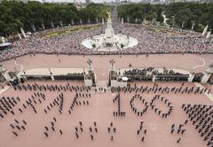 RAF personnel forming 'RAF100' sign at Buckingham Palace with crowds in The Mall, London