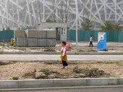 Kid with butterfly wings in front of a stadium