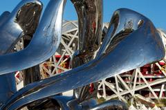 Beijing National Stadium known as the Birds Nest with a sculpture in the foreground