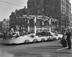 Aalsmeer flower parade in Amsterdam featuring a wagon decorated with flowers resembling the Magere Brug