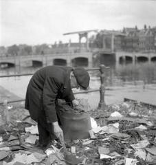 Portrait of a man searching for waste in a moat, Amsterdam