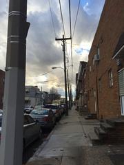 sunset with big clouds over an urban street