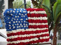 'A nos morts' statue with the American flag in Cannes, France