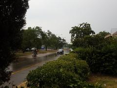 people riding a bike in the rain during Ramadan in Islamabad, Pakistan