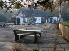 Boathouse Restaurant and outside seating area by Bracebridge Pool on a sunny day