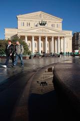 Bolshoi Theatre with reflections in puddles