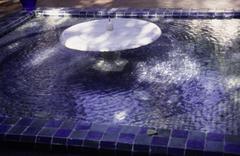 Fountain in a square basin with blue mosaic in Majorelle Garden