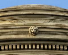 Architectural detail with lion's eyes bearing a human eye photograph