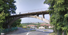 Ponte sul Rino bridge over a river with surrounding foliage