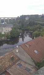 view of a river branch in L'Isle-Jourdain with the viaduct in the background