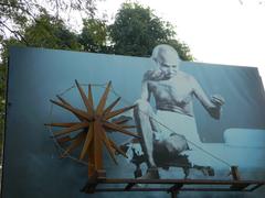 Mahatma Gandhi with a charkha at the entrance of Gandhi Ashram