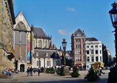 Dam Square in Amsterdam with historical buildings and people