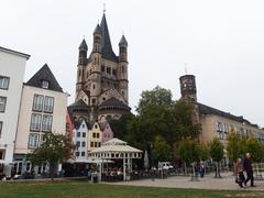 Scenic view of Cologne Fischmarkt with historic colorful buildings and a church tower