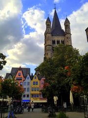 A panoramic view of Cologne cityscape with the Cologne Cathedral prominently visible.