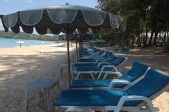 view of Kata Beach in Thailand with blue ocean and a few scattered clouds