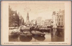 Amstel river view from Halvemaansbrug towards Muntplein featuring historical buildings and Munttoren