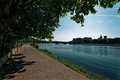 Panoramic view from the Rhône riverbank capturing Pont Saint Bénézet, Avignon landmarks, and Pont Édouard Daladier