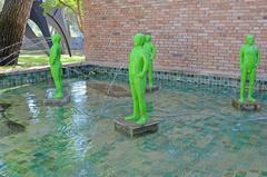 Four green bronze sculptures Hommes de Bessines by Fabrice Hybert at Fondation Maeght entrance