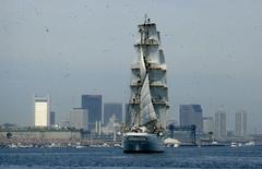 Tall ship in Boston Harbor with Boston waterfront in background