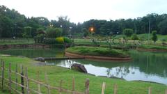 Japanese garden with a large stone boundary and vibrant greenery in Pune