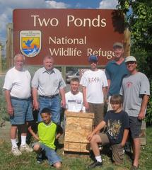 Young Eagle Scout group building and installing bat box habitat in nature