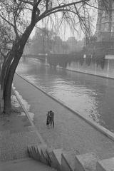 A couple walking along the Seine River in Paris