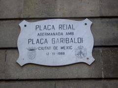 Placa Reial square in Barcelona with palm trees and traditional architecture