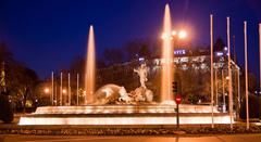 Fuente de Neptuno illuminated at night in Madrid