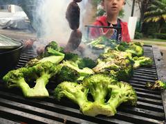 Chorizo and broccoli grilling on a barbecue