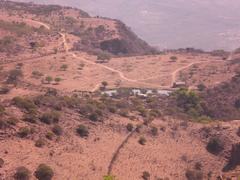 Panoramic view of Agua En El Cerro with trees and mountains in the distance