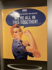 1940s woman showing muscles saying We're all in this together